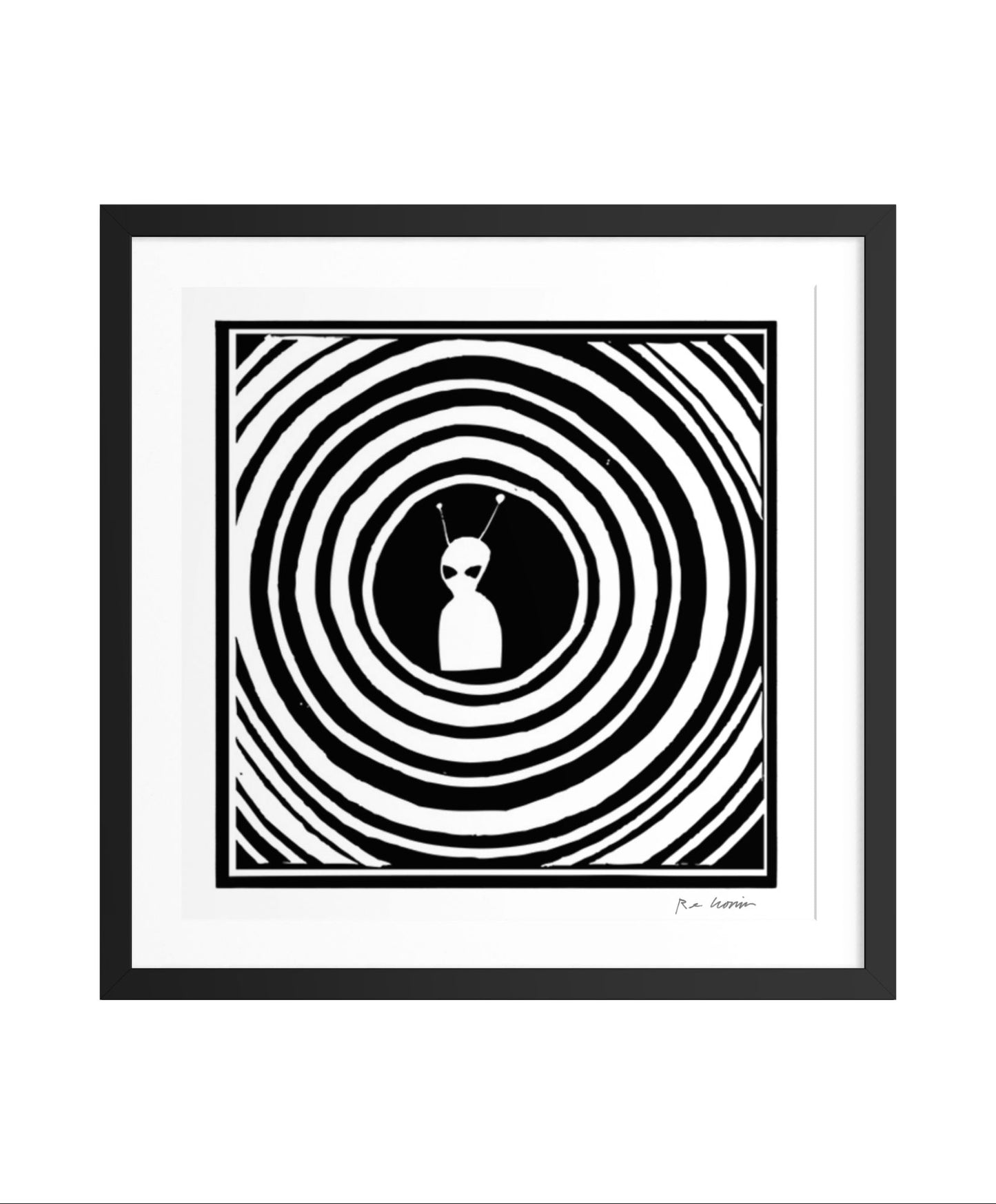 Framed black and white artwork with an alien figure and concentric circles.