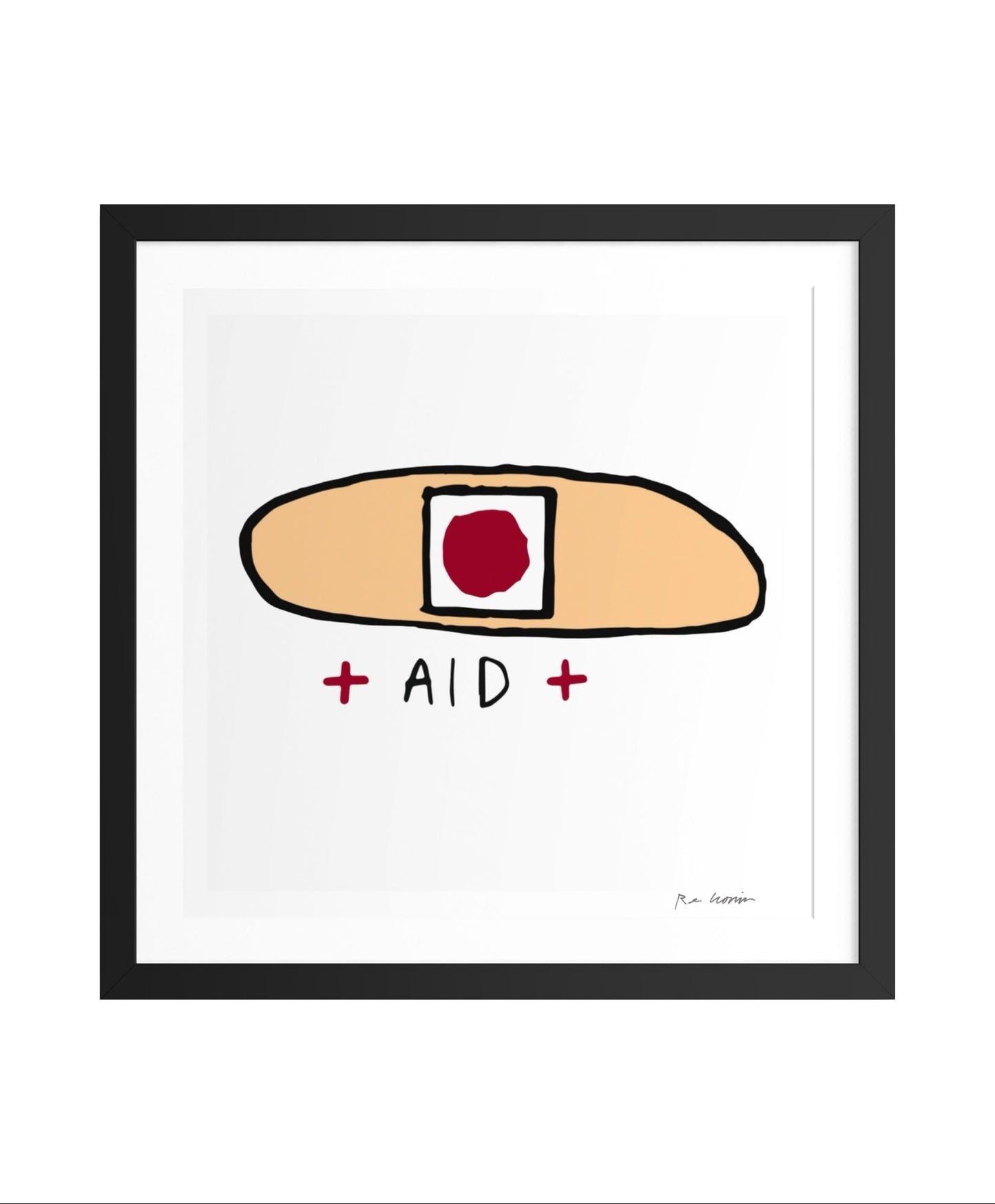 Framed artwork of a bandaid with 'AID' text on a white background