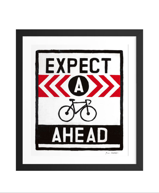 Framed artwork with 'Expect a bike ahead' text and graphic