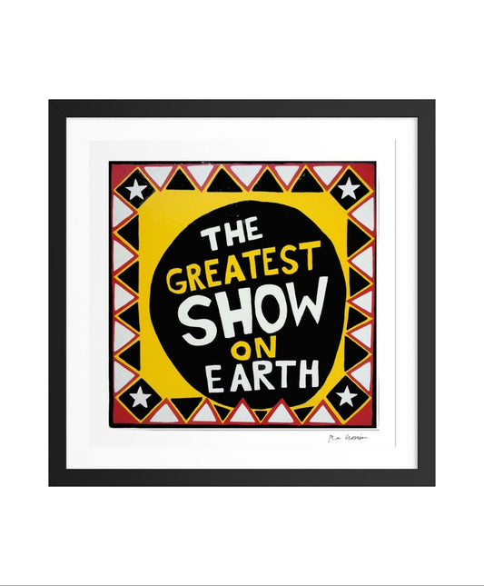 Framed artwork with 'The Greatest Show on Earth' text in a decorative border.