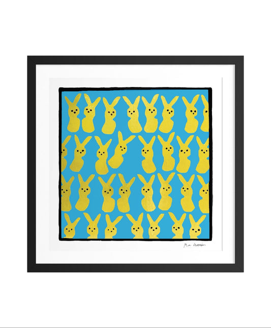 Framed artwork with a pattern of yellow cartoon-like bunny rabbit figures resembling peeps marshmallow candy on a blue background