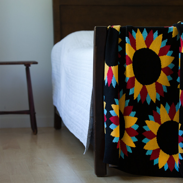 black recycled cotton throws and blankets with sunflower print, designed by Artist Ryan Cronin